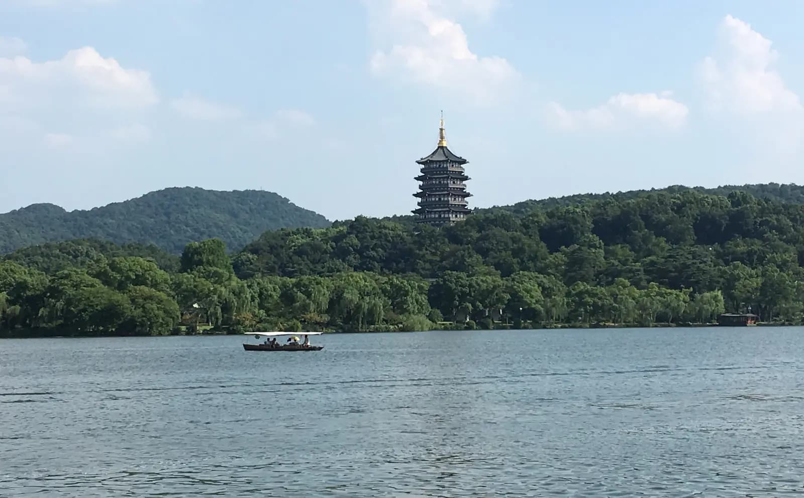 Leifeng Pagoda rising above the wooded southern shore of West Lake